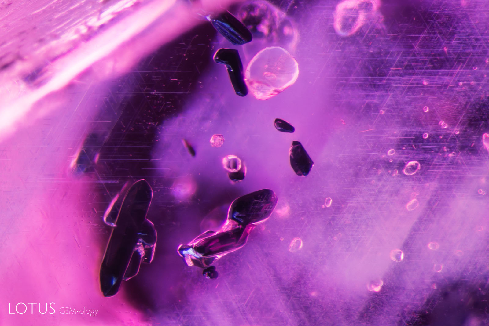 (Unheated) Sample 37 shows dark crystals of primary rutile, along with clouds of exsolved rutile silk.