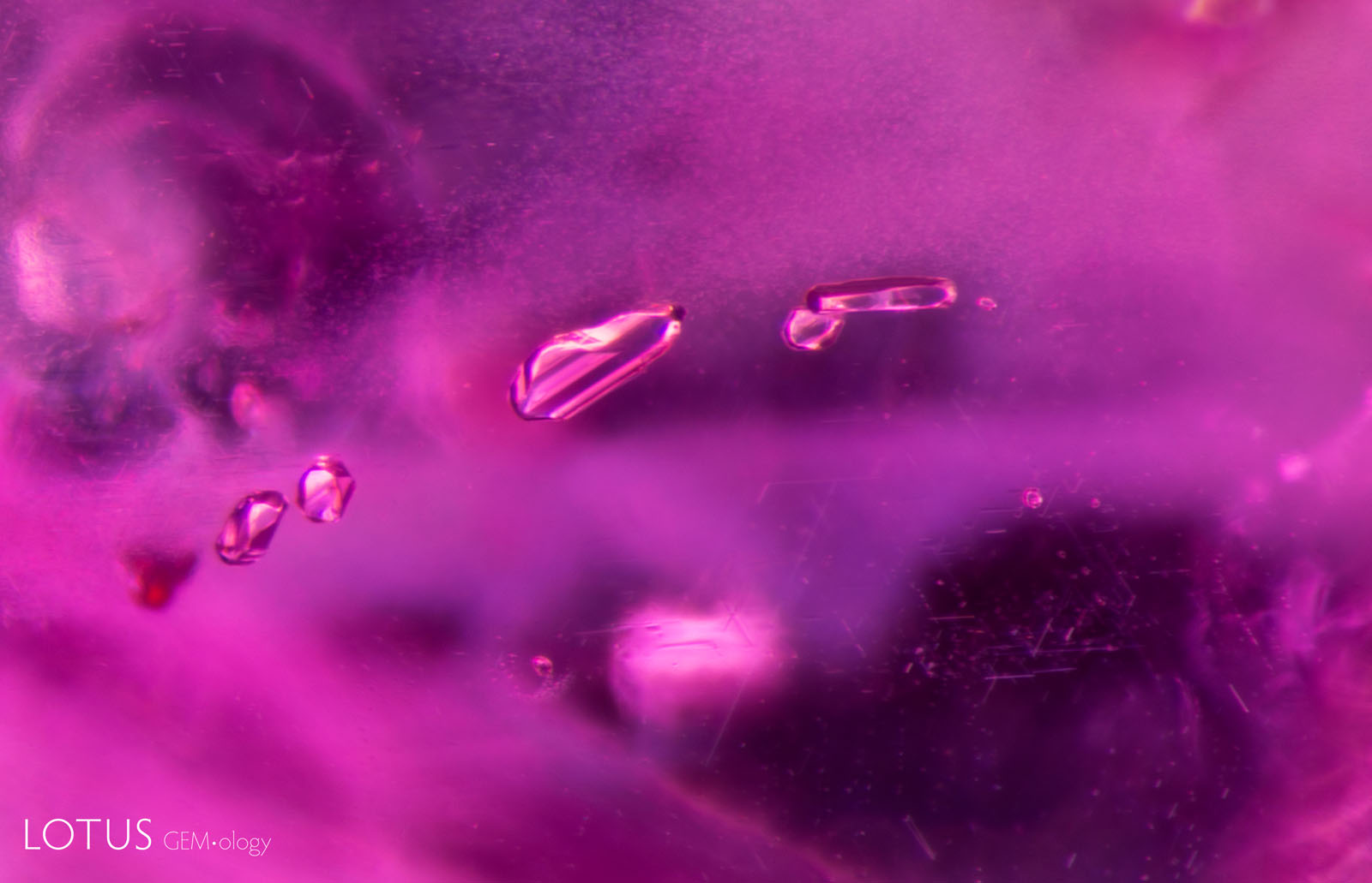 (1100°C) The feldspar crystals are intact and appear unaffected by heat. However, discoid fissures appear in the background at the top left and bottom right.