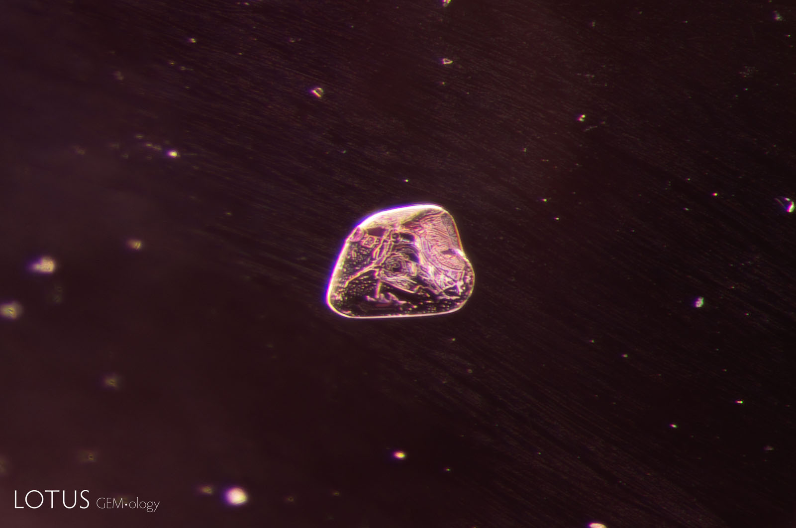 (1100°C) The spinel crystal has begun to change in appearance and started to develop elongated lines.