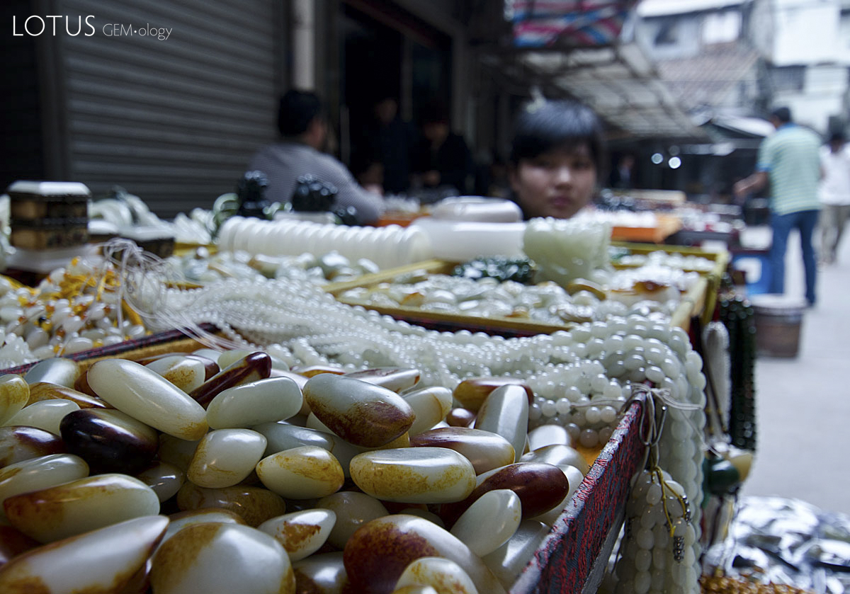 Figure 13. What appears to be Chinese nephrite in Guangzhou's Hualin Street jade market. The stains on the surfaces of these stones are possibly artificial. Photo: Richard W. Hughes.