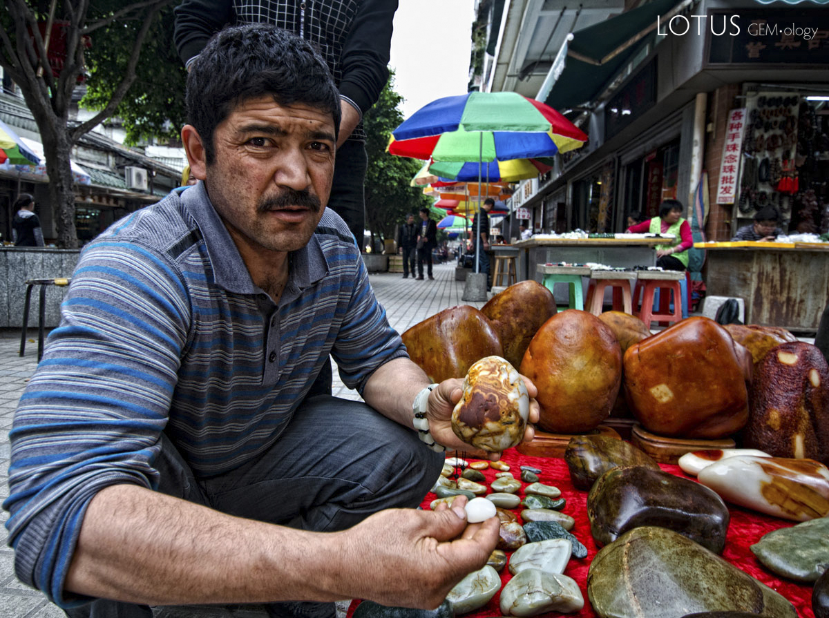 Figure 5. A Uighur man showing what looks like Chinese nephrite in Guangzhou's Hualin Street jade market. Photo: Richard W. Hughes.