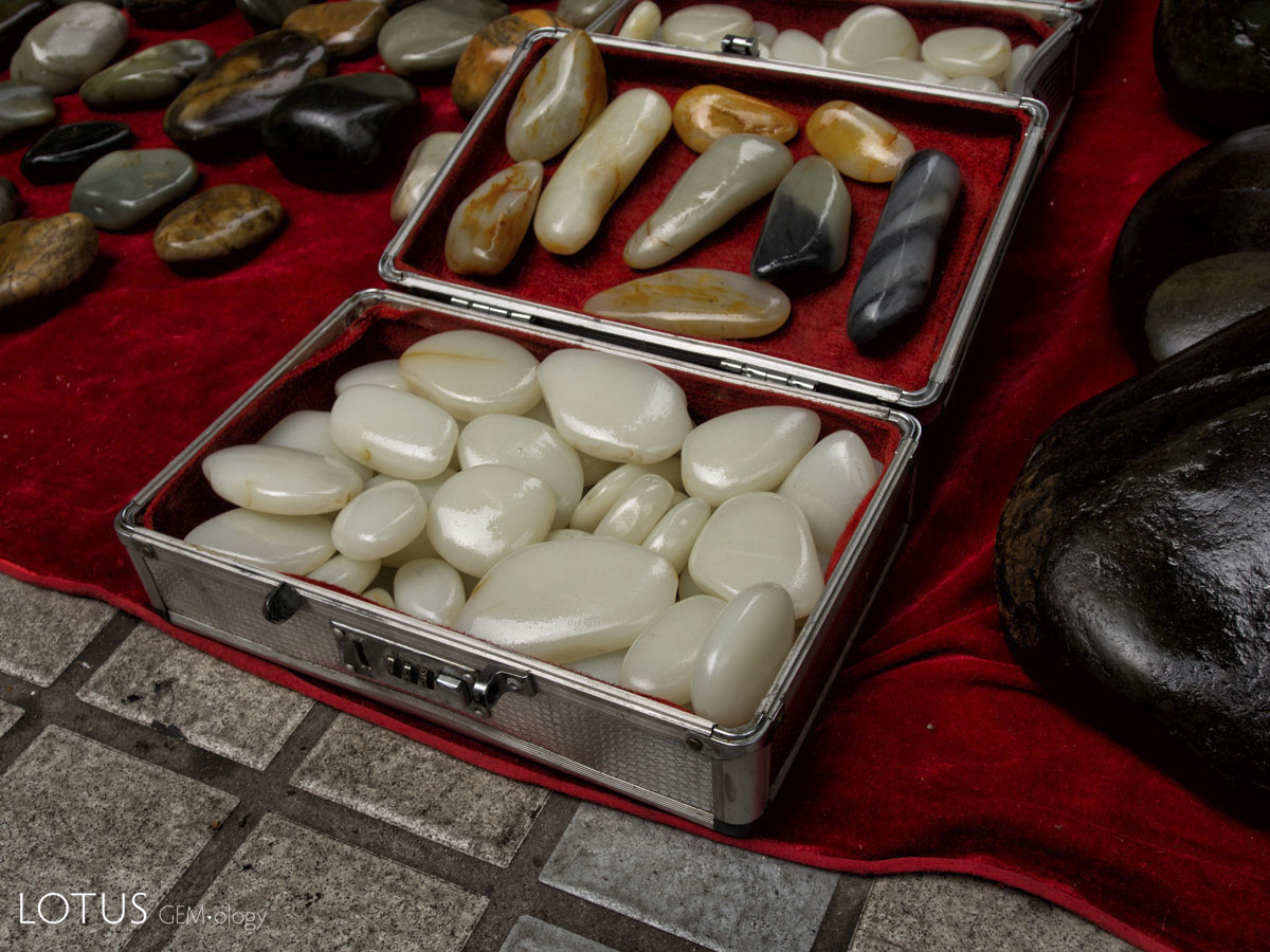 Figure 6. A suitcase of what appears to be Chinese nephrite in Guangzhou's Hualin Street jade market. Like many gem markets, caveat emptor is the norm as imitations abound. Photo: Richard W. Hughes.
