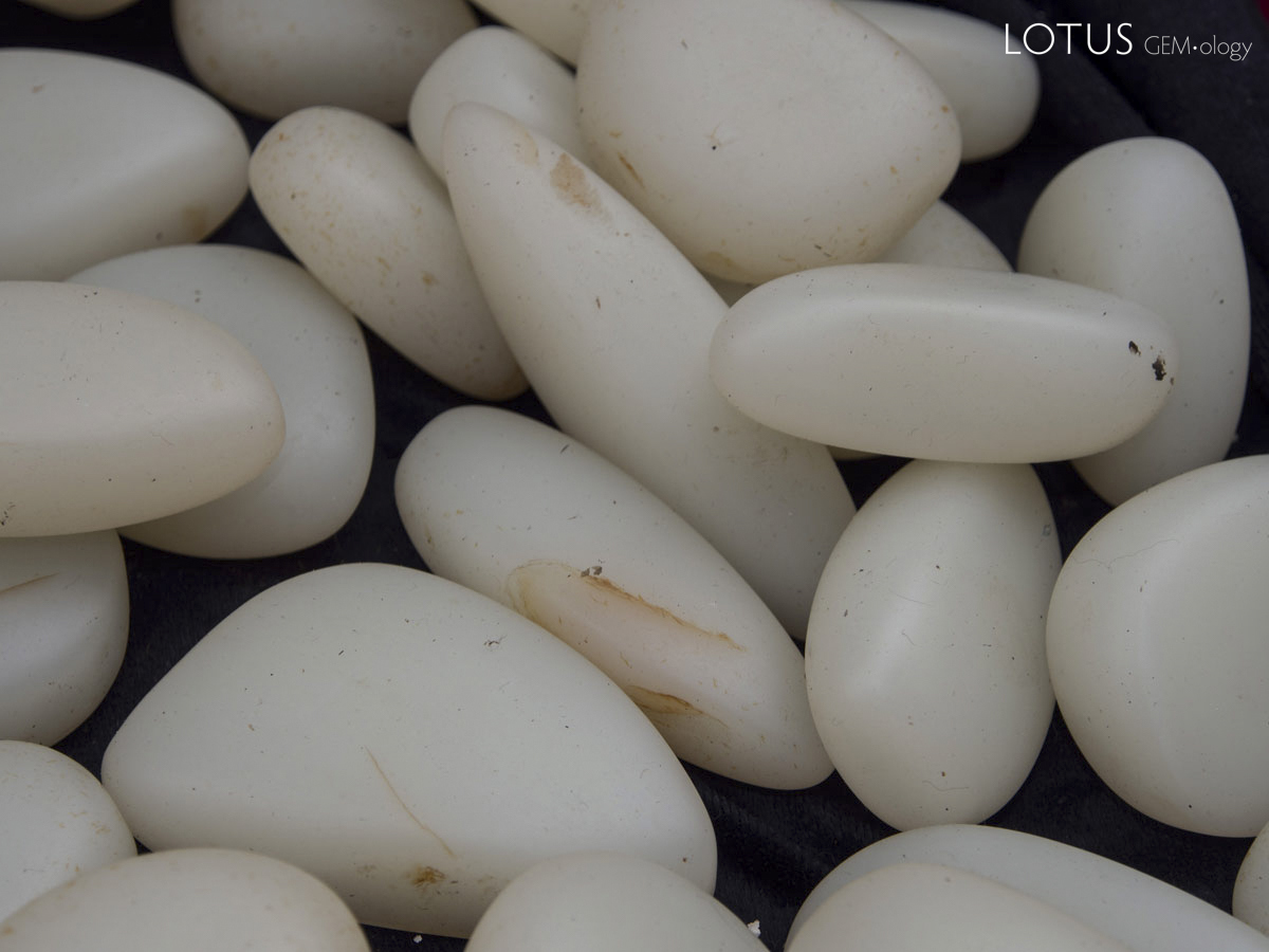 Figure 12. What appears to be Chinese nephrite seen in Guangzhou's Hualin Street jade market. Some of these feature obvious iron-oxide stains. Photo: Richard W. Hughes.