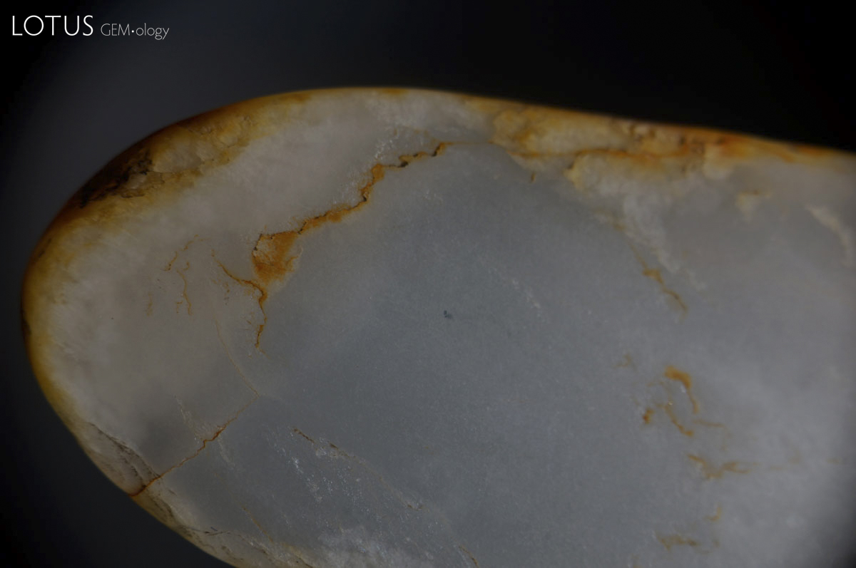 Figure 11. Chinese white nephrite with iron oxide stains purchased in Guangzhou's Hualin Street jade market. Photo: Wimon Manorotkul.