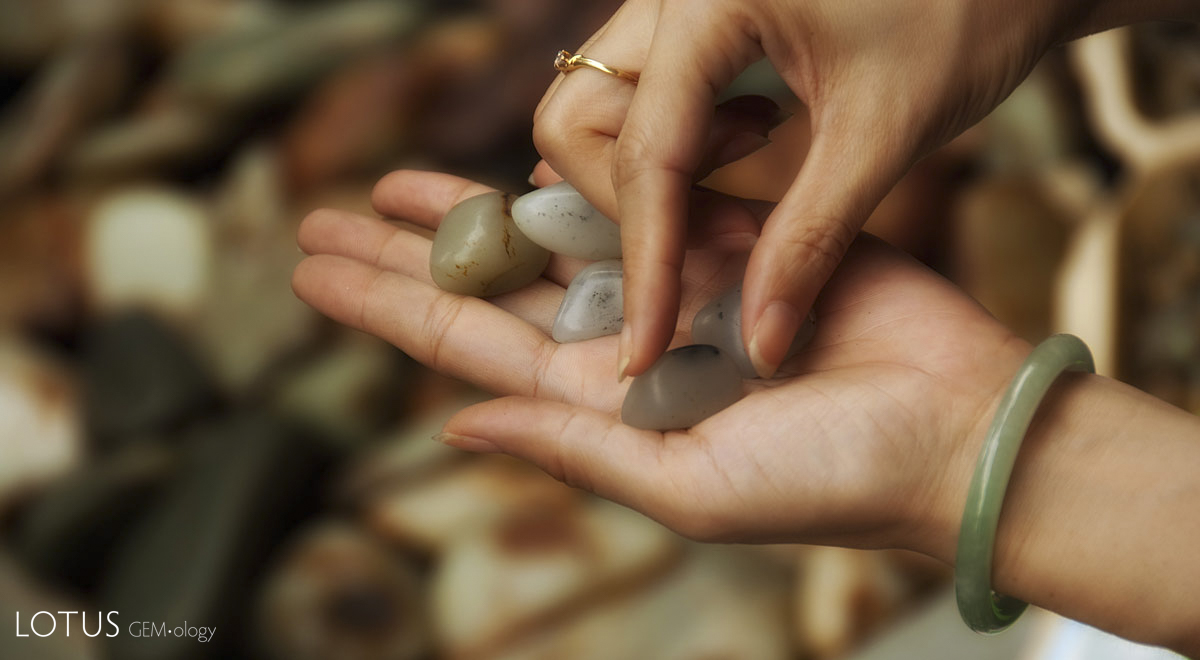Figure 3. Jade pebbles being examined by a prospective buyer in Guangzhou's Hualin Street jade market. Photo: Richard W. Hughes.
