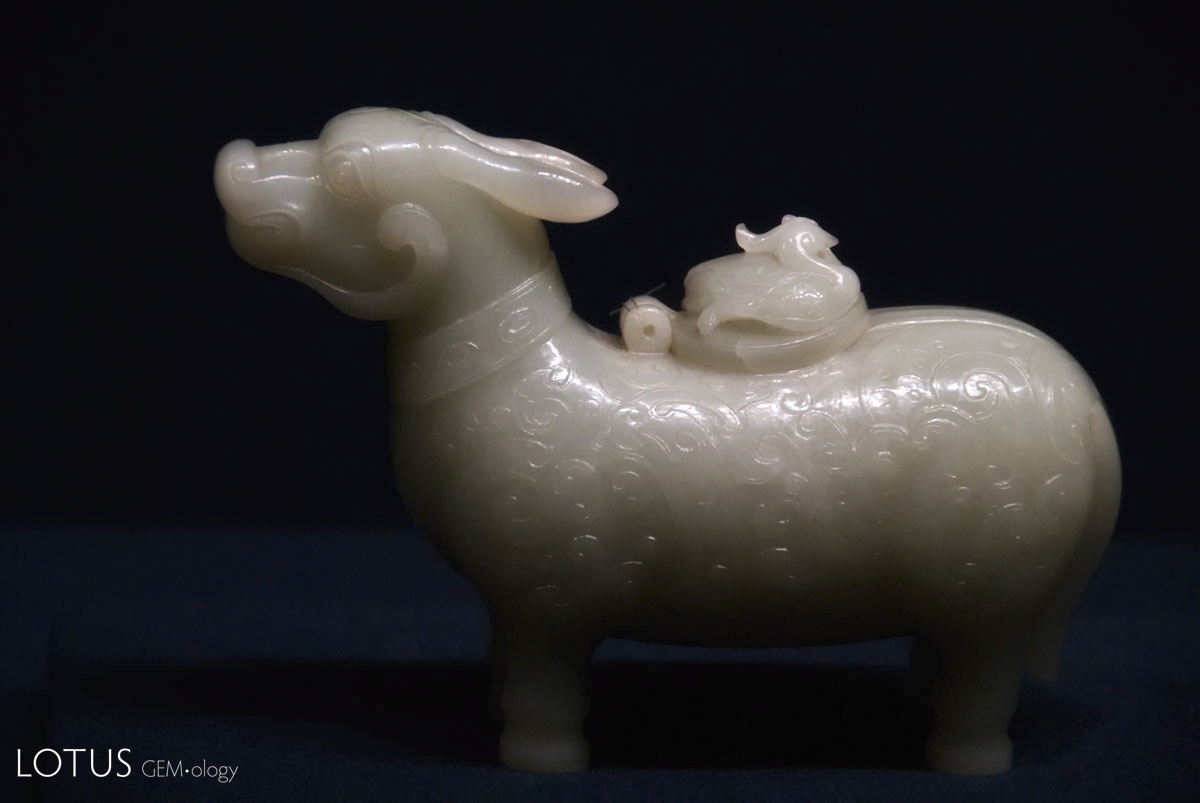 Figure 12. Ox-shaped xun (wine vessel) carved from Chinese nephrite on display in Shanghai's Shanghai Museum. Quianlong Reign (AD 1736–1795). Qing Dynasty. Over the past two decades the Chinese have rediscovered their love of nephrite jade, with the white stone from Hotan now fetching near-jadeite prices. Photo: Richard W. Hughes.