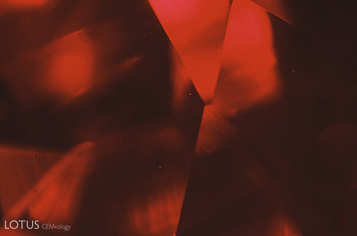 Figure 3. Using darkfield illumination this Kashan flux-grown synthetic ruby looks virtually flawless. Magnified 15&times;. Photomicrograph &copy; John I. Koivula, microWorld of Gems.