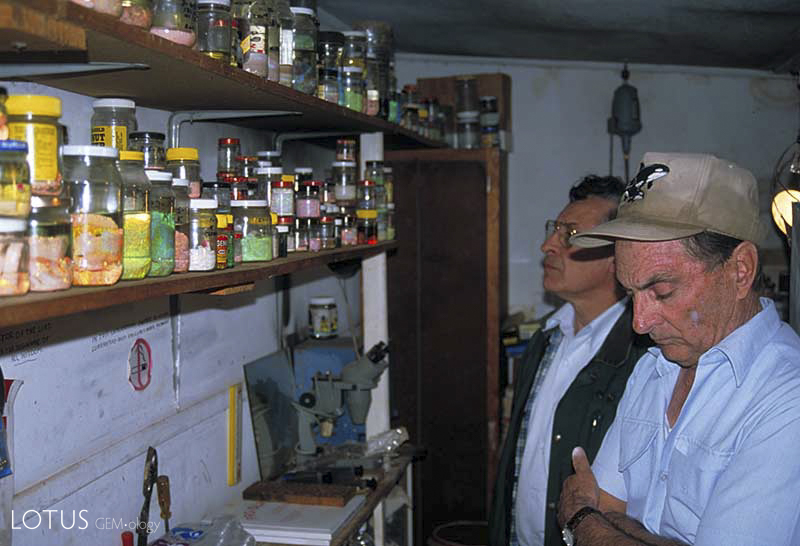 Lenny Cram (far right) and Terry Coldham in Lenny Cram's shed outside his house in Lightning Ridge, Australia.