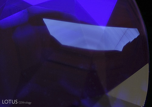 Figure 11. Distant and magified views of another superficial fluorescent patch in an untreated sapphire from Madagascar. Photos: Richard W. Hughes; Nikon D200