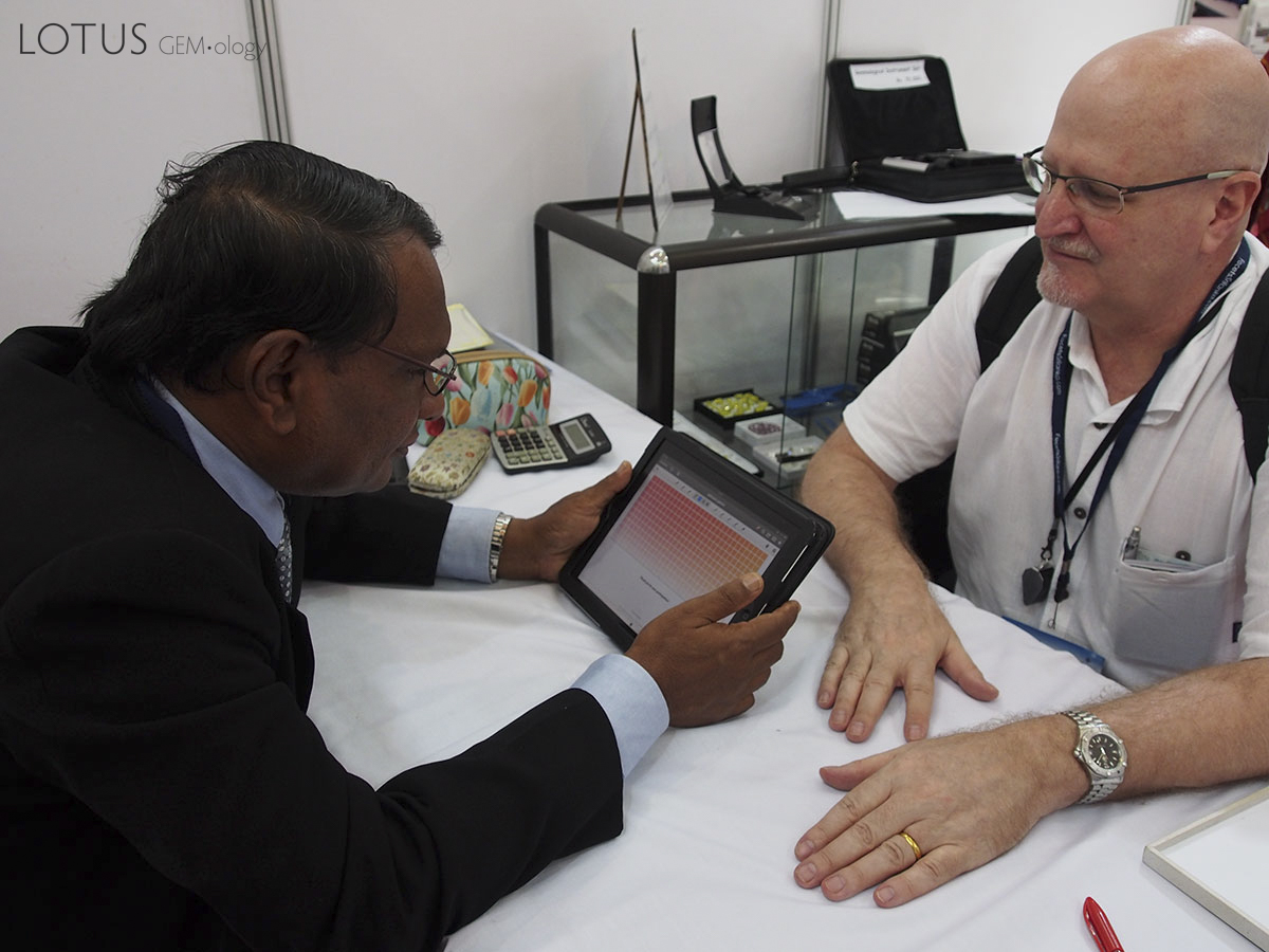 Figure 6. Padparadscha survey Sri Lankan gem expert, Gamini Zoysa (left) taking the padparadscha survey as the author looks on. Photo: Wimon Manorotkul.