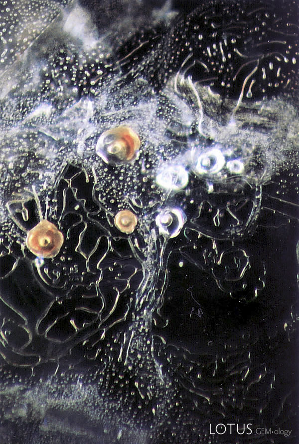 Inclusions in Sapphires From the banal to the bizarre, the latest Photoatlas covers the entire gemological waterfront, as this scene from a heat-treated Montana sapphire shows.