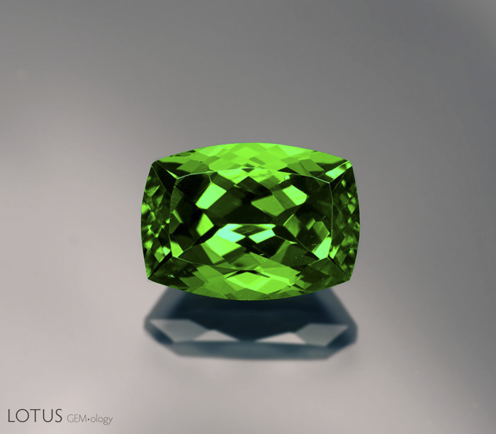 Figure 13. The color of this 7-ct tsavorite garnet is darker on the ends than in the center. This is not due to pleochroism&mdash;garnet is singly refractive&mdash;but an illustration of the Beer-Lambert law, where longer light paths result in greater absorption. Gem: Palagems.com; photo: Wimon Manorotkul