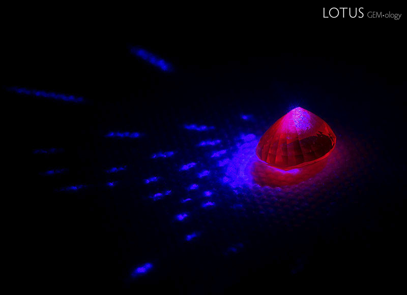 Ruby glowing red under blue light