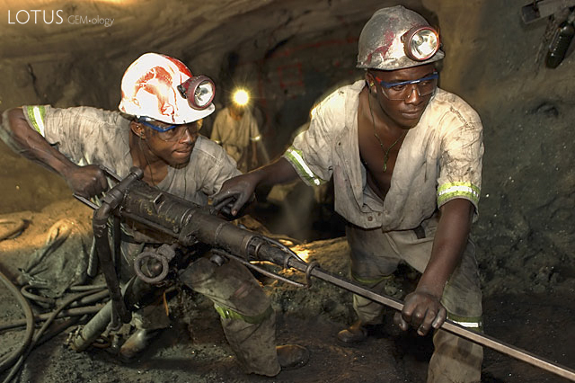 Miners work the face in TanzaniteOne's Block C mine. The extraction process begins with brute force, but ends with the utmost care to avoid damaging the gems. Unlike the other blocks, mining conditions at Block C are excellent and the company has a fine safety record. Photo: TanzaniteOne