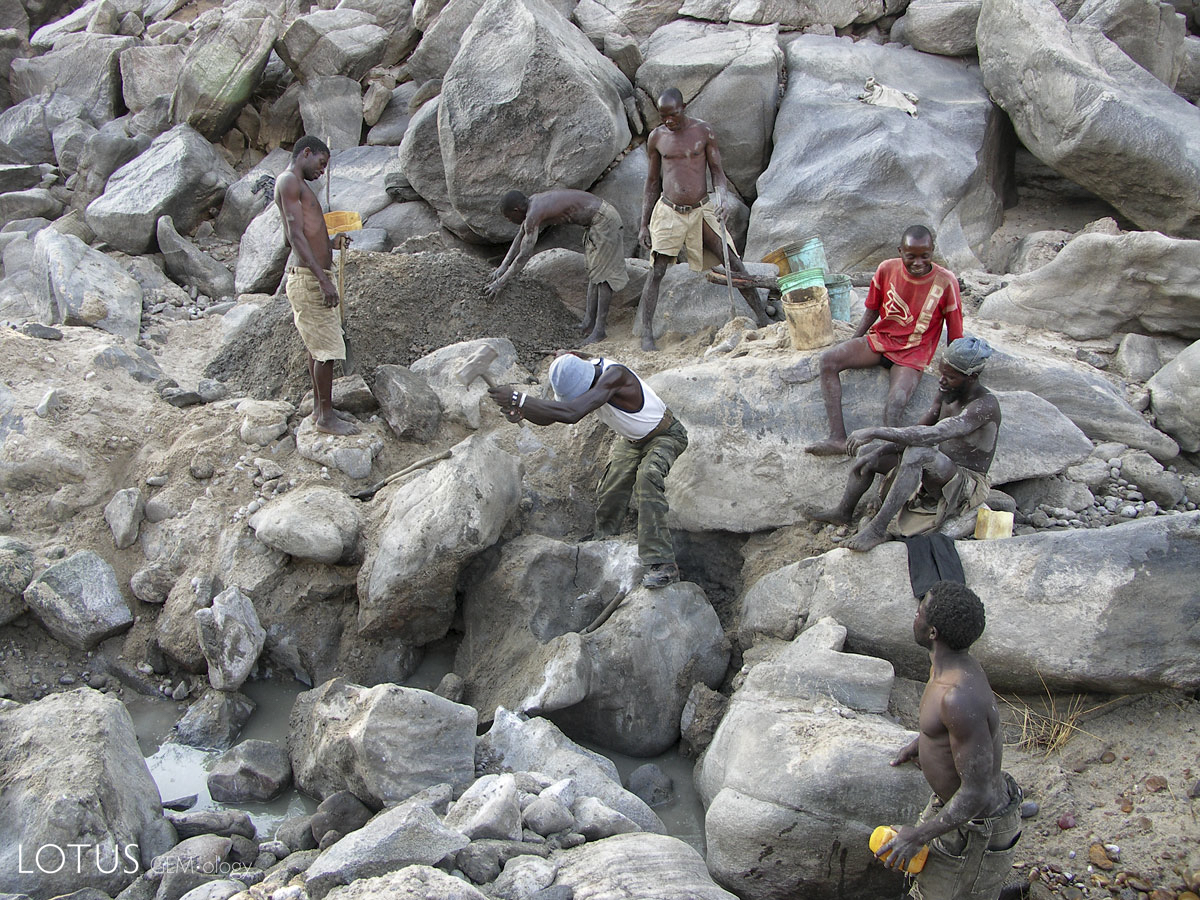 Miners work the dry riverbed at the Muhuwesi river in Tanzania's Tunduru district. River mining at Muhuwesi river can be difficult work; to reach gem-bearing gravels it is sometimes necessary to break large rocks and even then the mine production can be weak. Photo: Vincent Pardieu