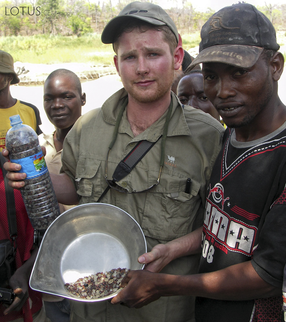 Drink up Warne Chitty with a group of friendly natives along the Muhuwesi river in Tanzania's Tunduru district. Chitty, from Aspen, Colorado, had recently graduated from GIA. At the time of our field trip, he was studying for his FGA, but he and his father were able to join us in Tanzania. Photo: Vincent Pardieu