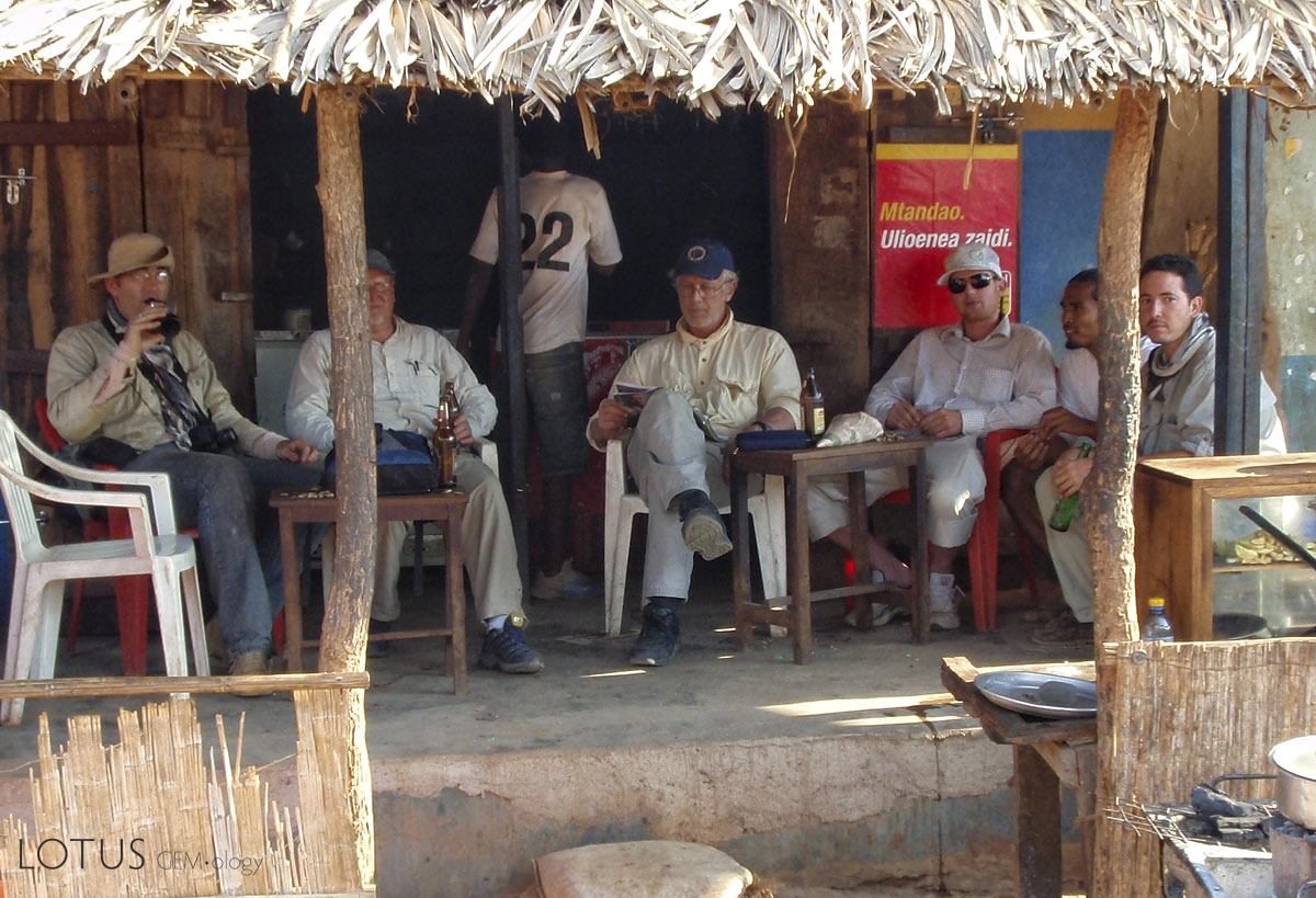 The Insane Gem Posse in Majimaji, enjoying a few semi-cool ones after a hard day beating the bush for sapphires along Tunduru's Ruvuma River. Left to right: Vincent Pardieu, Richard Hughes, Monty Chitty, Warne Chitty, Michael Rogers and the Franco-Mada love bunny, Guji Soubiraa. Photo: Philippe Brunot