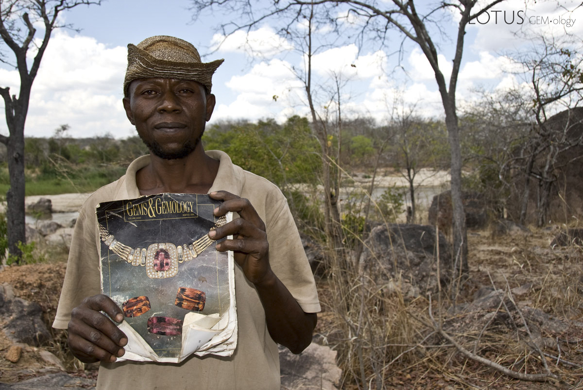 Miner Joseph Mayunga displays one of his prize possessions, a Gems & Gemology magazine that includes an article on the gems of Tanzania, given to him by a Sri Lankan dealer after a successful chrysoberyl deal. At the time of our visit in October, 2007, Joseph had been living and mining at the Muhuwesi river for more than seven years. Photo: Richard W. Hughes