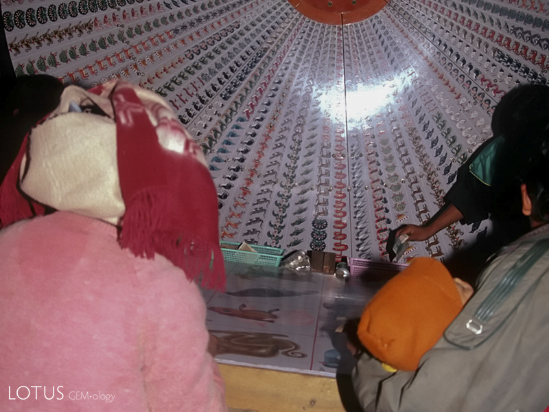 Gambling fever At nightfall, many of the towns of Jade Land morph into miniature Las Vegases. Here an entire family watches a roulette wheel anxiously at Makapin. Note the small child asleep.