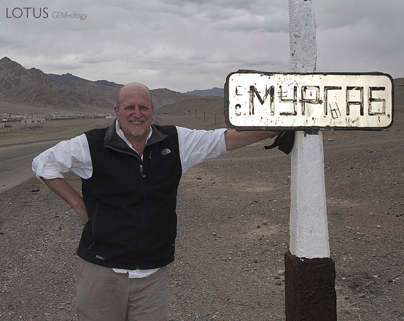 Richard Hughes on the outskirts of Murgab, in the remote Badakhshan region of Tajikistan. Imagine a photo of you next to the sign. Photo &copy; Richard W. Hughes.