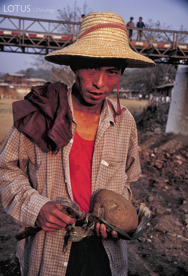 Figure 13. The color of luck Miner with jade at the Uru river tailings dump in the center of Hpakan. Photo &copy; Richard W. Hughes.