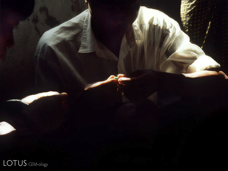 Figure 14. The color of money Examining jadeite in Hpakan. Photo &copy; Olivier Galibert.