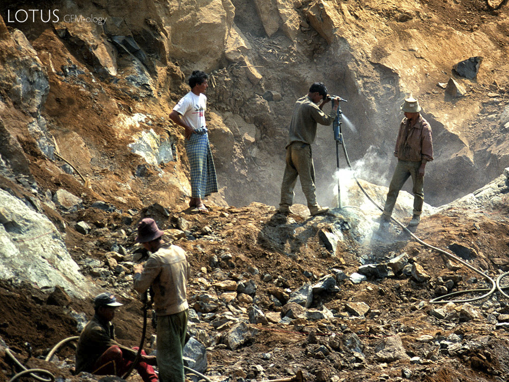 Figure 6. Once a dike is exposed at Tawmaw, jackhammers are needed to break the jadeite apart. Photo &copy; Richard W. Hughes.