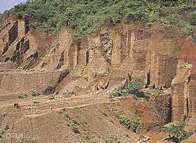 Figure 7. Mining of the Uru conglomerate is done in step-like claims approximately 5 m wide that were originally separated by thin "walls." Photo &copy; Olivier Galibert.