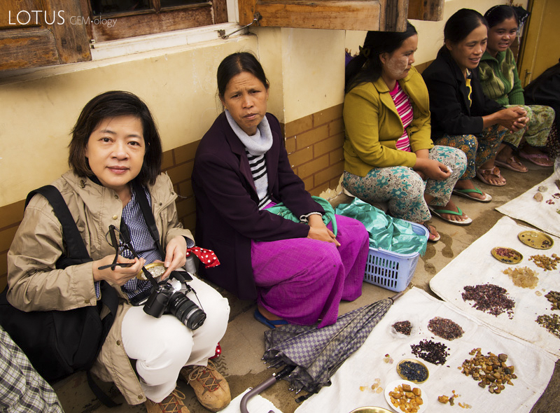 Figure 5. Wimon Manorotkul (left) joins dealers displaying rough gems in Mogok&rsquo;s market. Over fifty different types of gems are found in the Stone Tract.&nbsp;Photo: E. Billie Hughes
