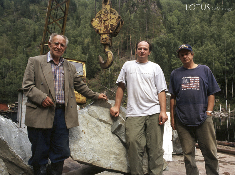Mikhail "Misha" Khrolenko (center) and his father Yakov Borisovich(left) and brother Sergei (right), owners of the Khakassia jade mines. They are standing in front of a huge chunk of Khakassia jadeite. Photo: &copy; Richard W. Hughes