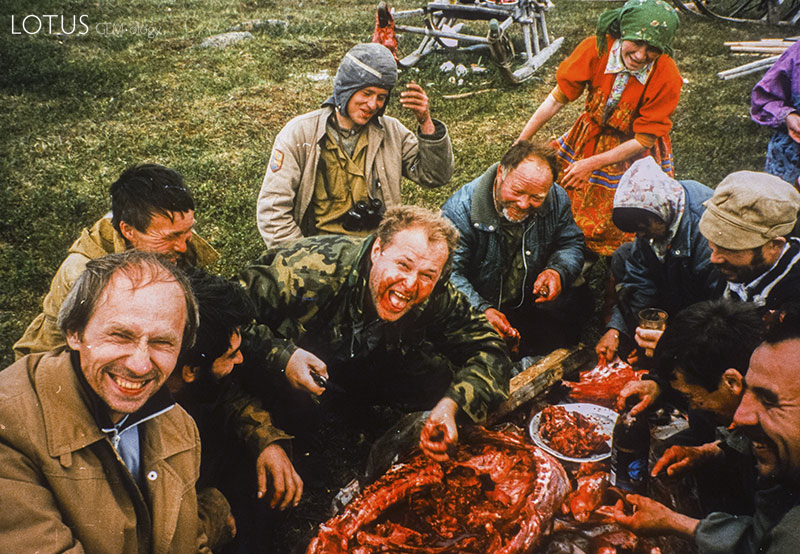 Nickolai Kouznetsov enjoying nyamnyukh (raw reindeer meat) and spirt (grain alcohol) with the Khant people near Kechpel (western Polar Urals).