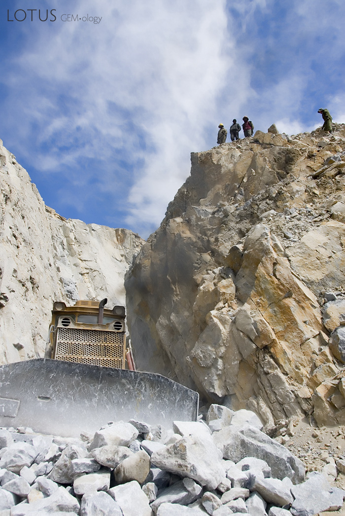 A bulldozer works the vein, while miners look on from above at the Snezhny ruby mines in eastern Badakhshan. Photo: Richard W. Hughes