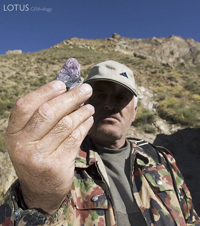 A miner at Kuh-i-Lal holds up a piece of impure spinel. Photo: Richard W. Hughes