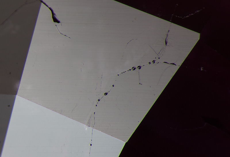 Oil coagulating on the surface of a Burmese ruby after gentle heating with the hot point.